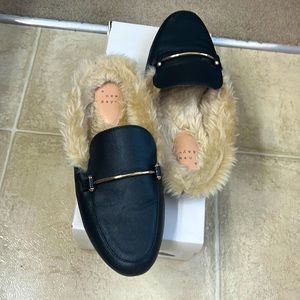 Black fur lined slip on flats in box kept